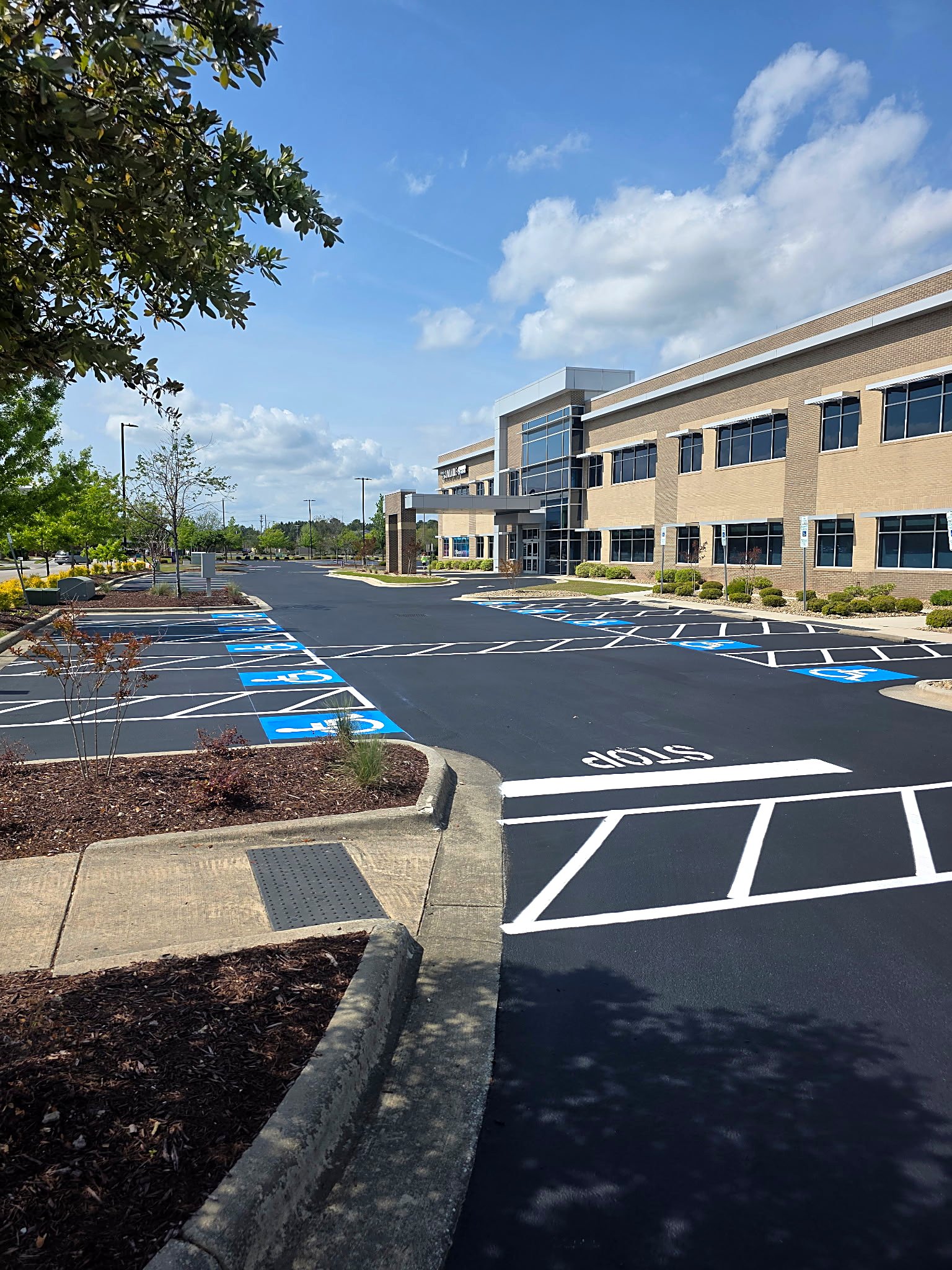 Freshly paved and striped medical office parking lot with ADA stalls in Concord, NC by Around Town Paving