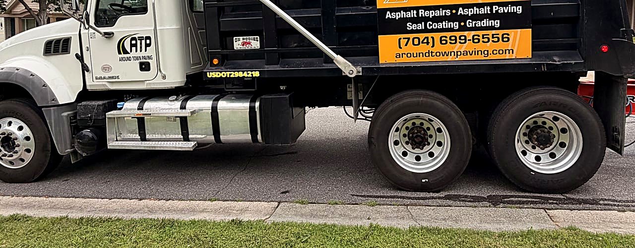 Around Town Paving branded dump truck parked curbside on a neighborhood paving job in North Carolina